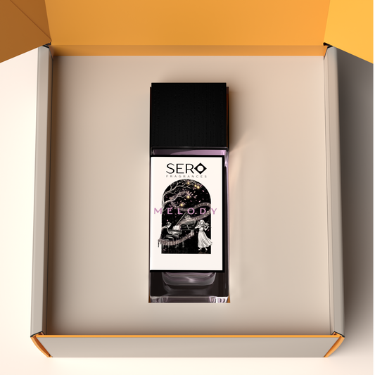 Top view of a packaging within it a minimalist clear glass perfume bottle with black wood cap containing SERO fragrance inspired by LV Symphonie.