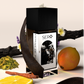 Coner view of a minimalist clear glass perfume bottle with black wood cap containing SERO fragrance inspired by  Penhaligon's Halfeti Leather. 