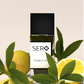 Sero Parfum with black bottle with lemons and green leaves on a light background
